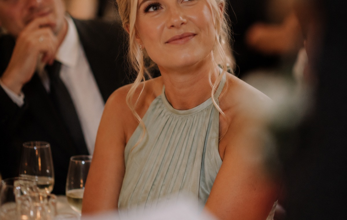 Wedding guest smiling while watching a speech