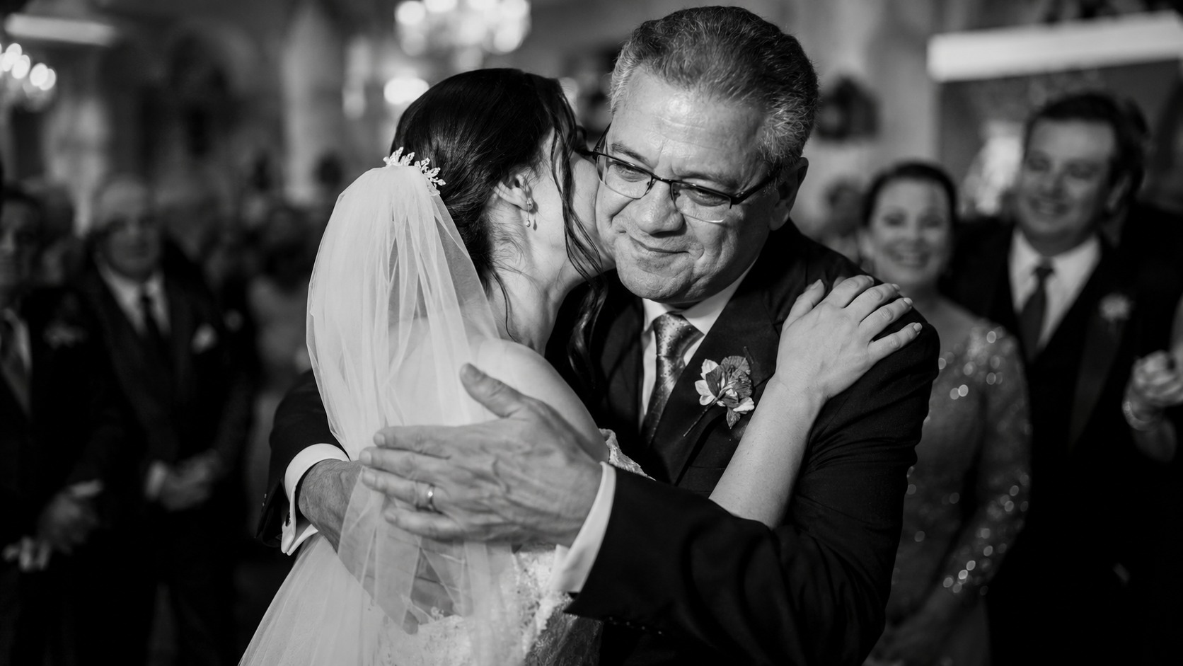 A candid emotional black and white wedding moment